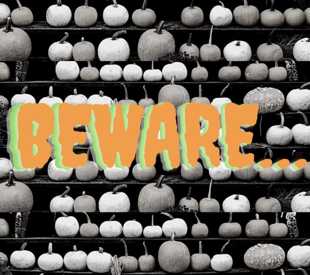 beware text in front of rows of pumpkins