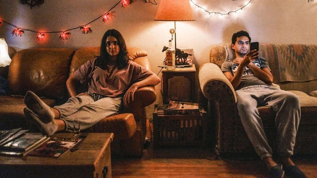 a man and a woman sitting on two different sofas