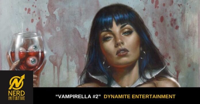 Portrait of a woman with blue-dyed hair holding a wine glass containing eyeballs; promotional art for Vampirella #2 by Dynamite Entertainment with Nerd Initiative branding at the bottom left.