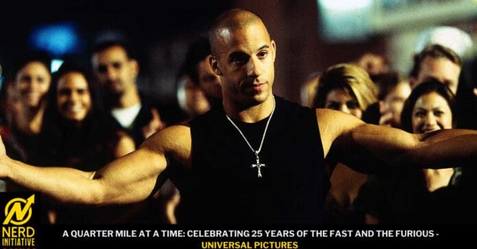 Muscular man with arms outstretched at a crowded event, wearing a black sleeveless shirt and a cross necklace; promotional banner references a Fast & Furious anniversary at the bottom.