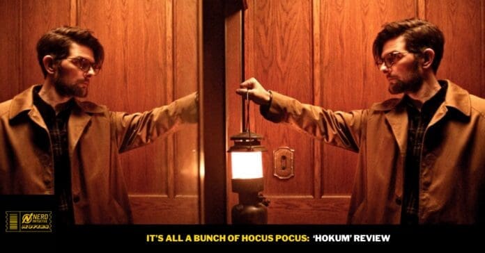 Man in a brown trench coat is mirrored on both sides of an elevator, reaching toward a glowing lantern between them.