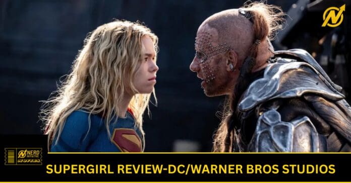 Young woman in a blue Supergirl costume faces a heavily armored, studded warrior in a dark setting.