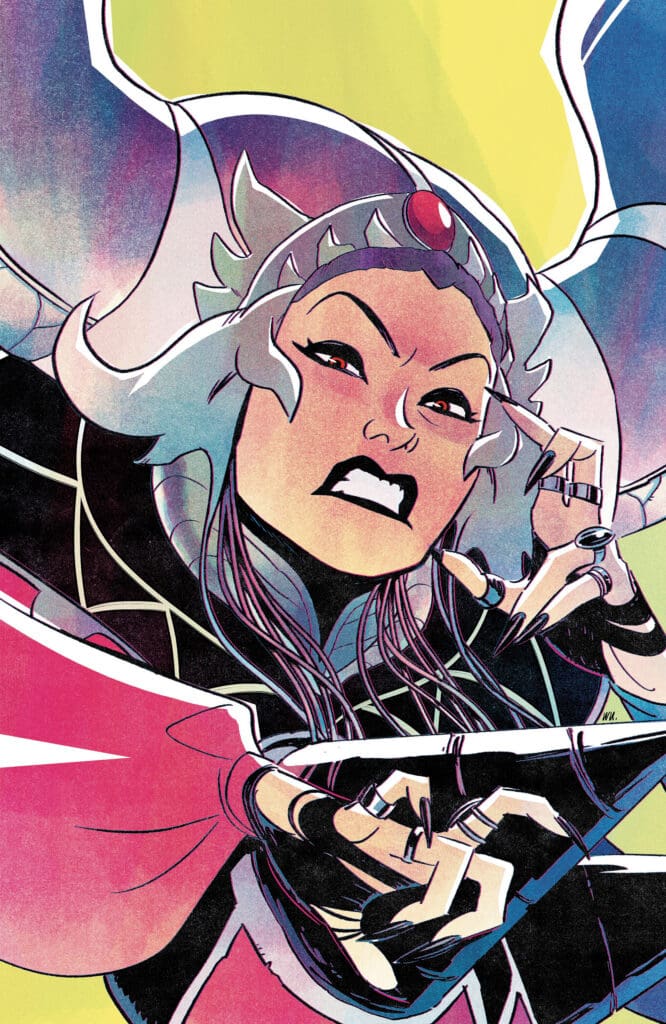 Fierce female superhero with silver hair and a red gem headpiece, snarling and reaching toward the viewer.
