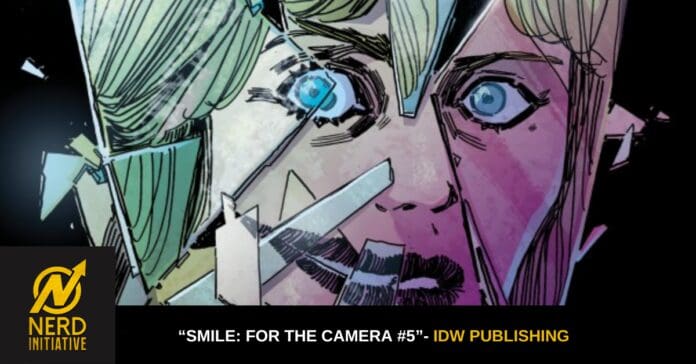 Close-up comic book cover: a woman's face with blue eyes and shattered glass fragments, logo for Nerd Initiative in the bottom-left corner, plus caption 'Smile: For the Camera #5' by IDW Publishing.