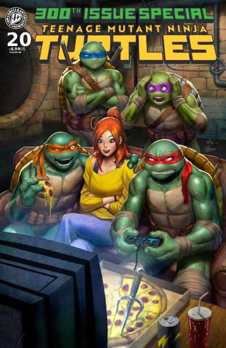 TMNT 300th Issue Special cover: four turtles with April O’Neil in a sewer lair, playing games with pizza nearby.