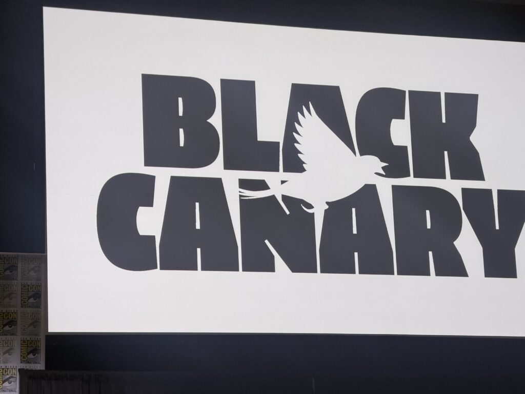 Sign reading BLACK GARDEN in bold black letters with a white dove graphic overlapping the text.