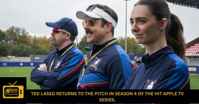 Three coaches stand on a sports field, wearing blue jackets and lanyards, looking off to the side with a banner headline about Ted Lasso in the foreground.